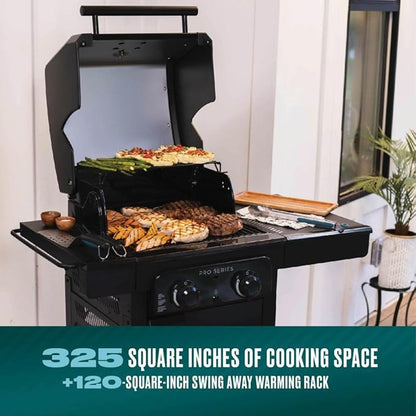 Portable grill with food on a patio, featuring text about cooking space and warming rack.