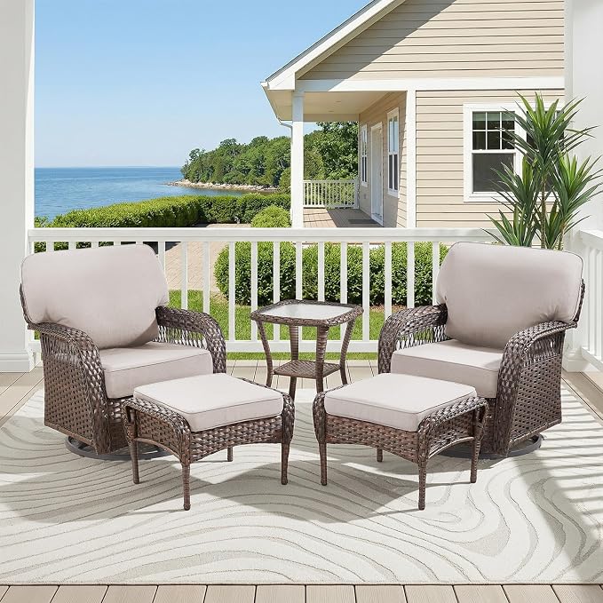 A 4-piece outdoor wicker furniture set with two club chairs, two ottomans, and a small square side table, arranged on a patio with a scenic ocean view background.