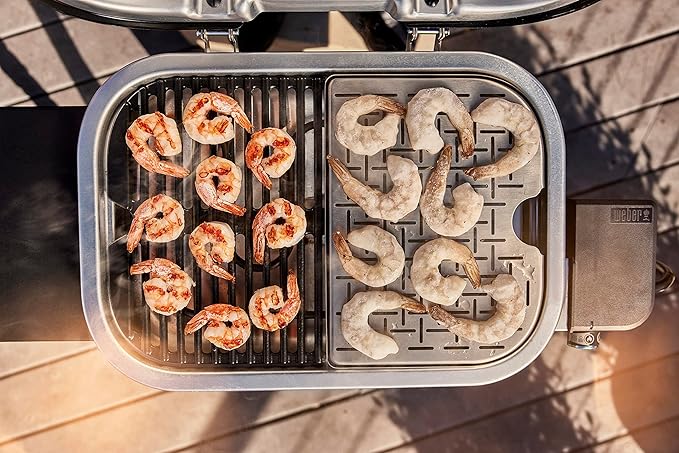 Shrimp being grilled on a portable grill with a waffle plate attachment.