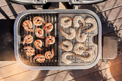 Shrimp being grilled on a portable grill with a waffle plate attachment.