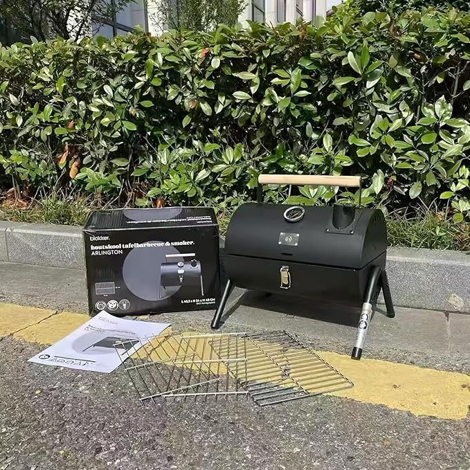 Portable charcoal grill with thermometer and double-sided grill net, suitable for camping and backyard smoking barbecue
