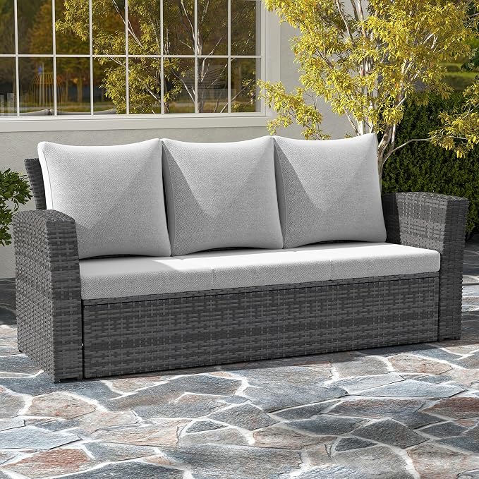 Gray outdoor sofa with cushions on a stone patio