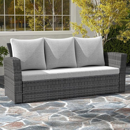 Gray outdoor sofa with cushions on a stone patio