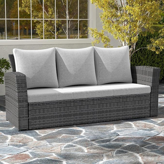 Gray outdoor sofa with cushions on a stone patio