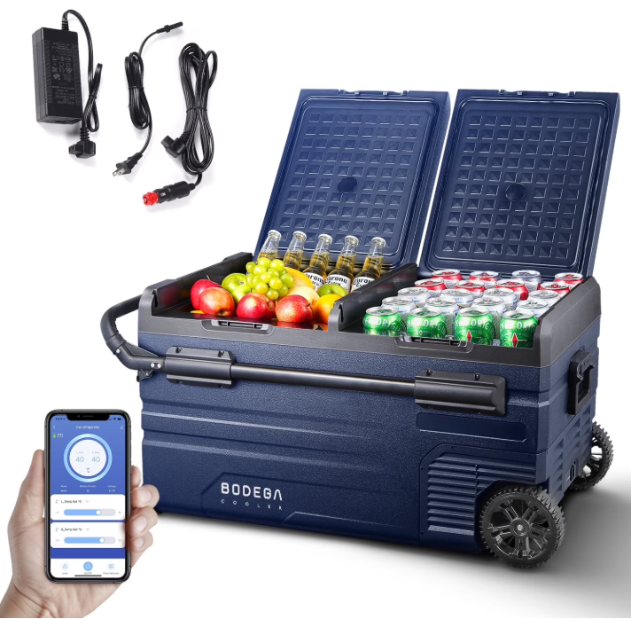 A dark blue BOOEBA electric cooler with wheels, shown open with drinks and fruit inside, alongside its power adapter and a hand holding a smartphone displaying the control app.